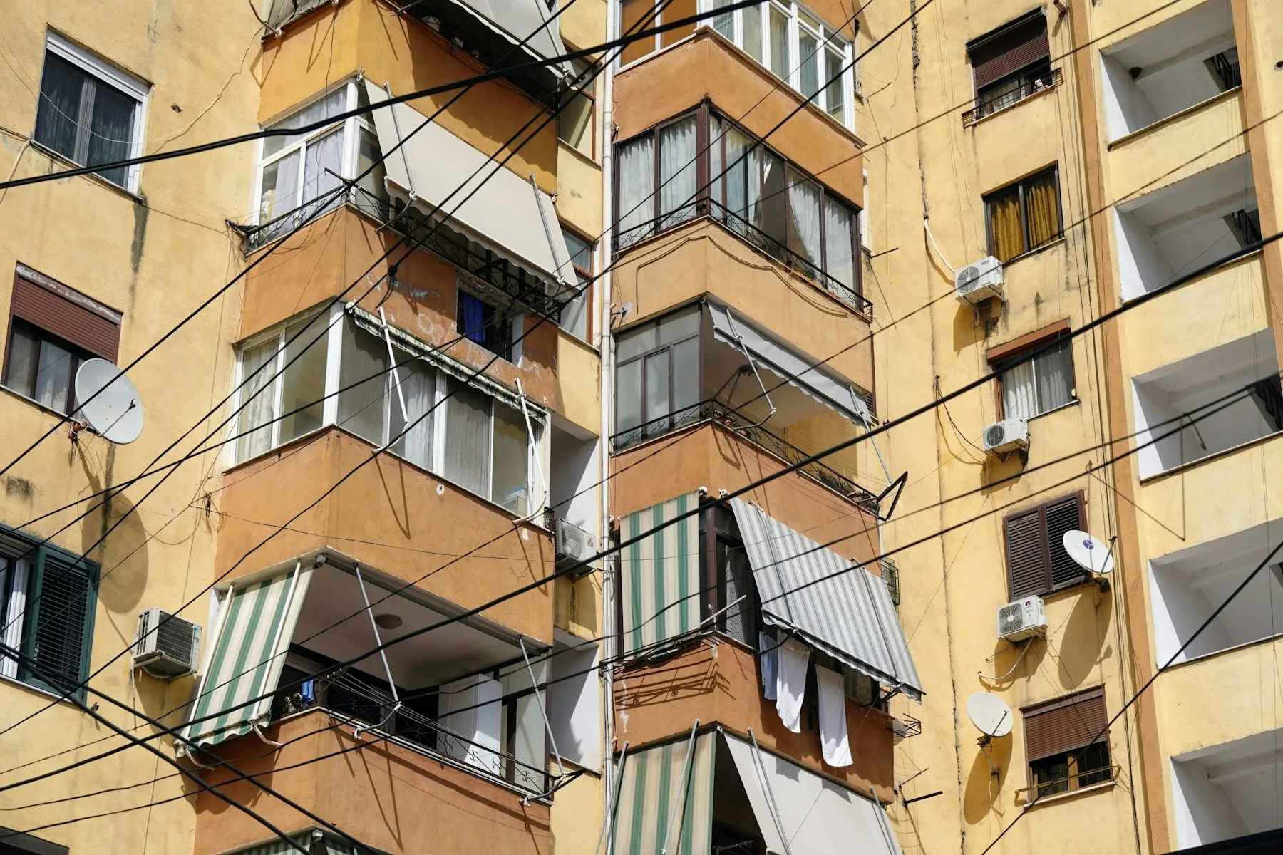 An apartment block with AC units fixed to its walls